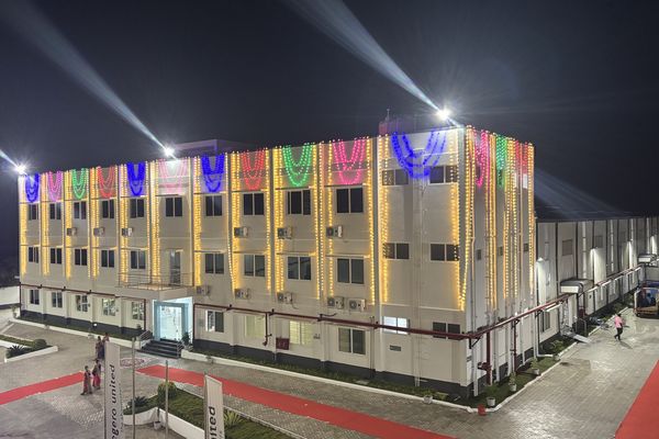 The new factory building was illuminated in vibrant colors for its inauguration.
